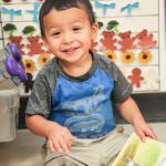 Photo of young hispanic boy smiling. Join flight to help homeless children.