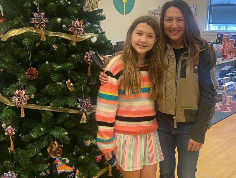 Mother and daughter in front of Christmas tree