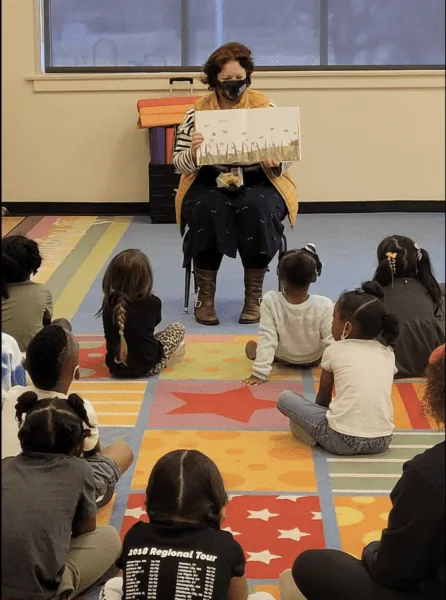 Teacher reads to young children during National Minority Health Month